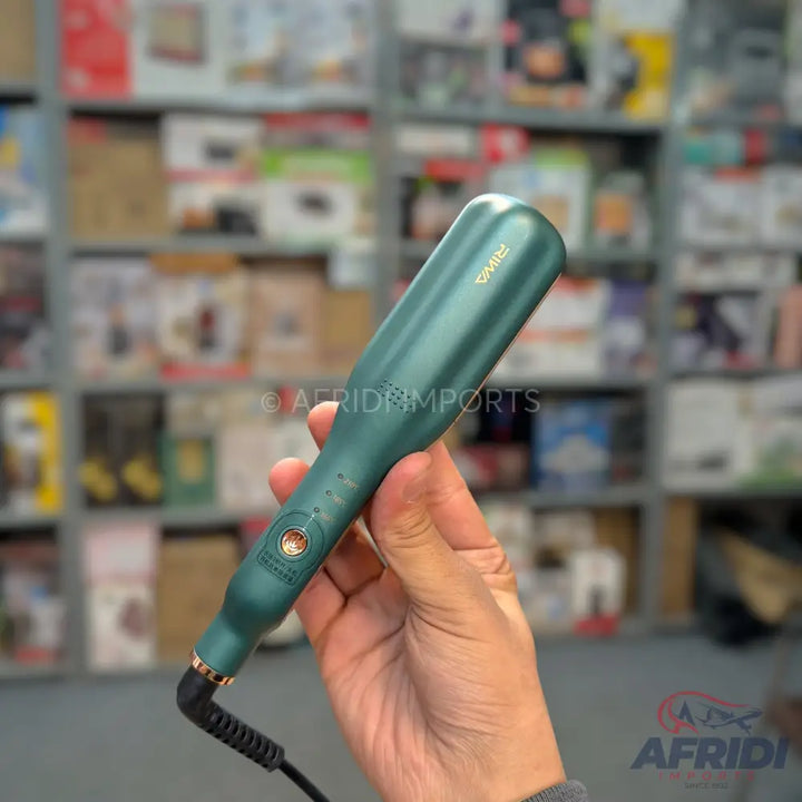Hand holding a green hair straightener with a swivel cord.