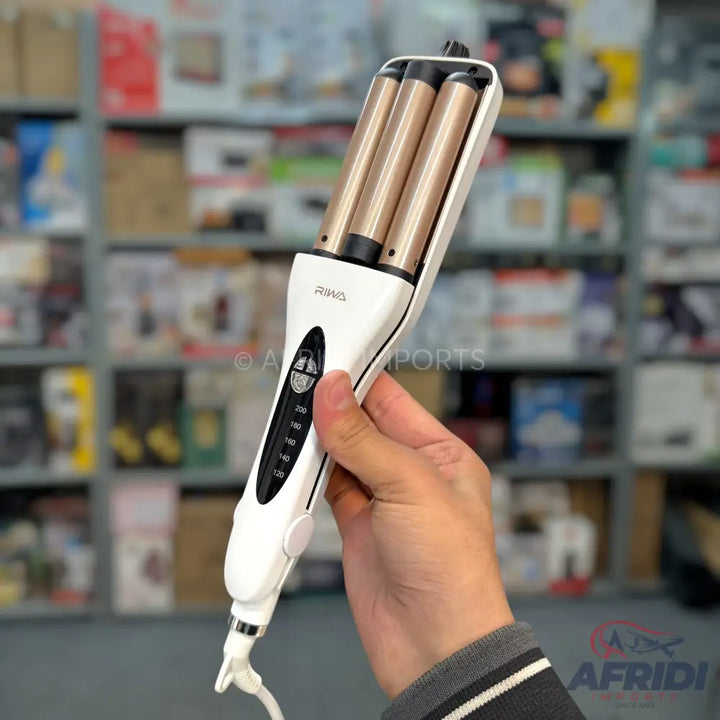 A white three-barrel hair waver with gold-toned ceramic barrels and adjustable temperature settings.