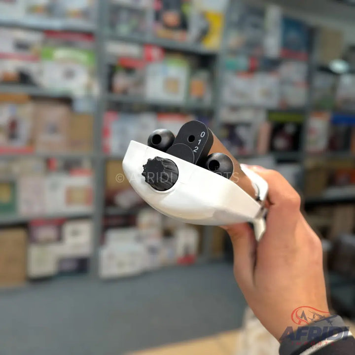 A white and black hair clipper with a numbered setting dial.