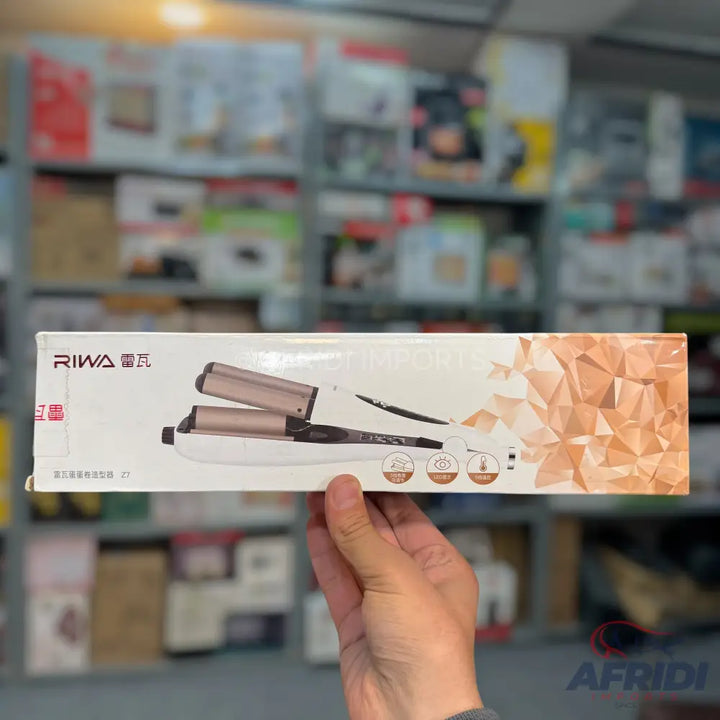A white and rose gold hair waver in its packaging.