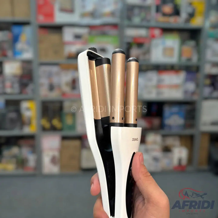 White and gold triple barrel hair waver for creating wavy hairstyles.