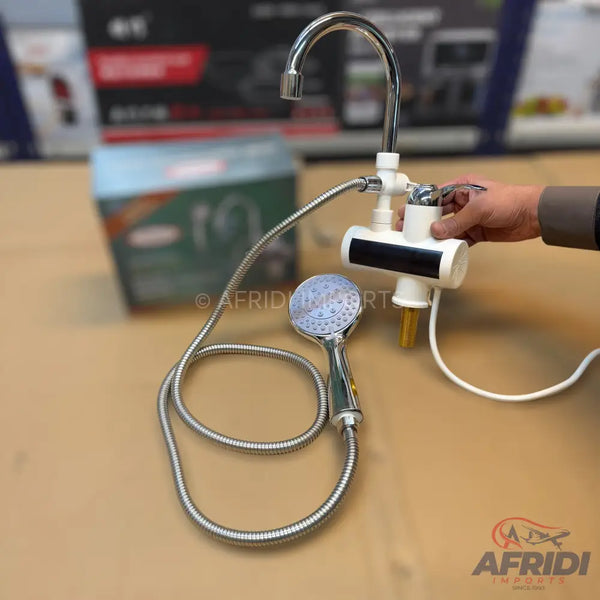 Instant electric water heater with a faucet and a handheld shower head.
