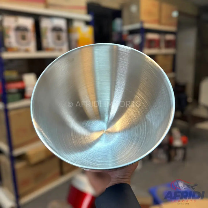 A shiny, brushed stainless steel mixing bowl.