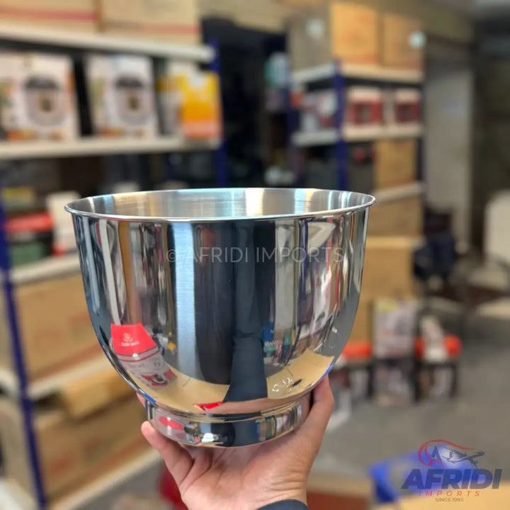 Polished stainless steel mixing bowl with a footed base.