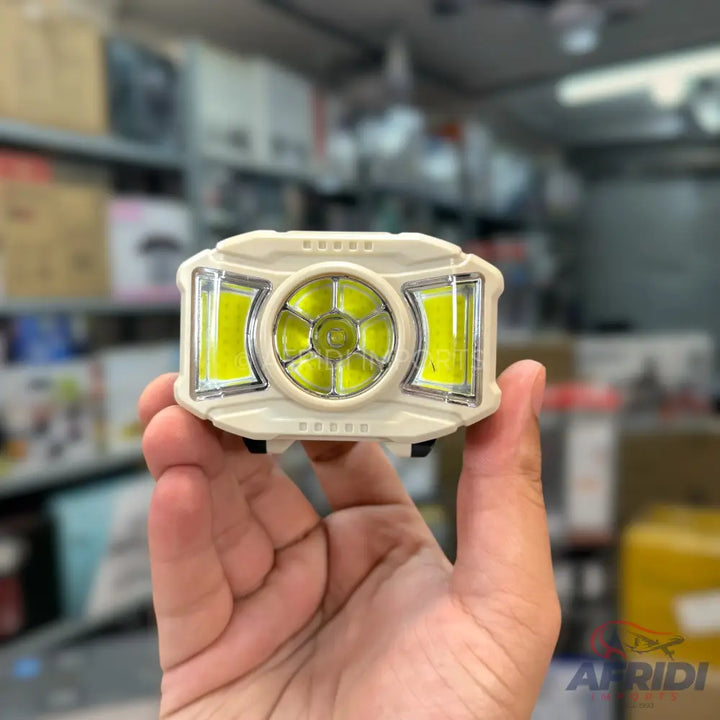 A beige, multi-LED headlamp with a central circular light and two rectangular side lights.