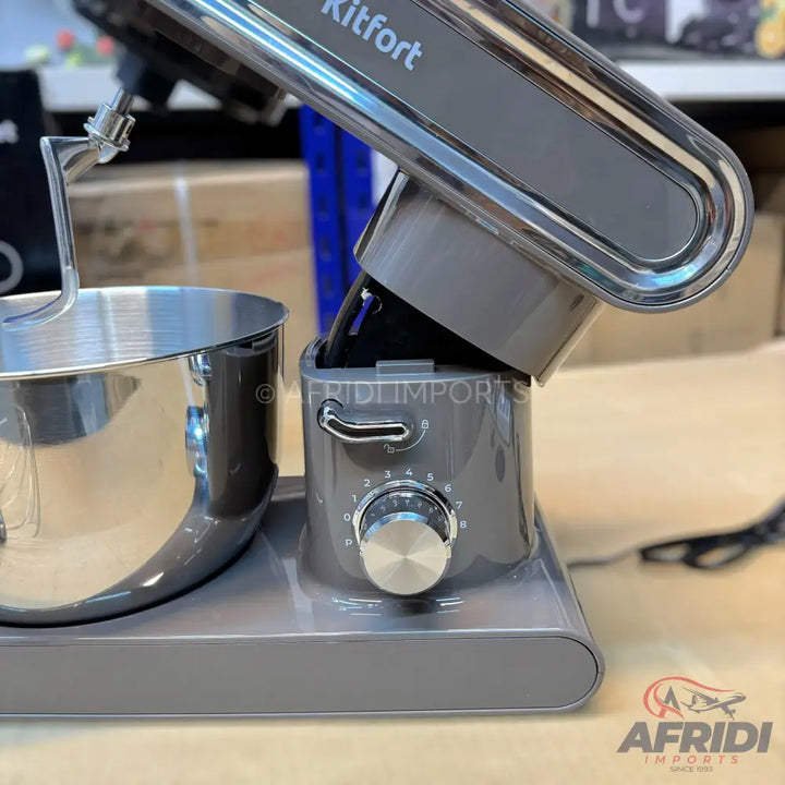 A grey stand mixer with a stainless steel bowl and a dough hook attachment.