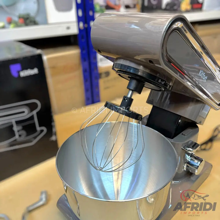 A grey stand mixer with a stainless steel bowl and whisk attachment.