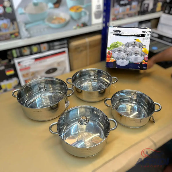 Set of four stainless steel pots with glass lids.