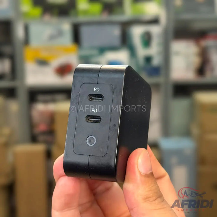 Black dual-port USB-C power adapter with Power Delivery (PD) functionality.