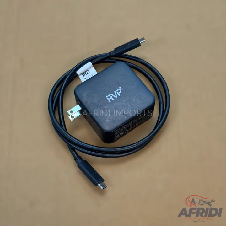 Black square-shaped power adapter with a coiled USB-C cable.