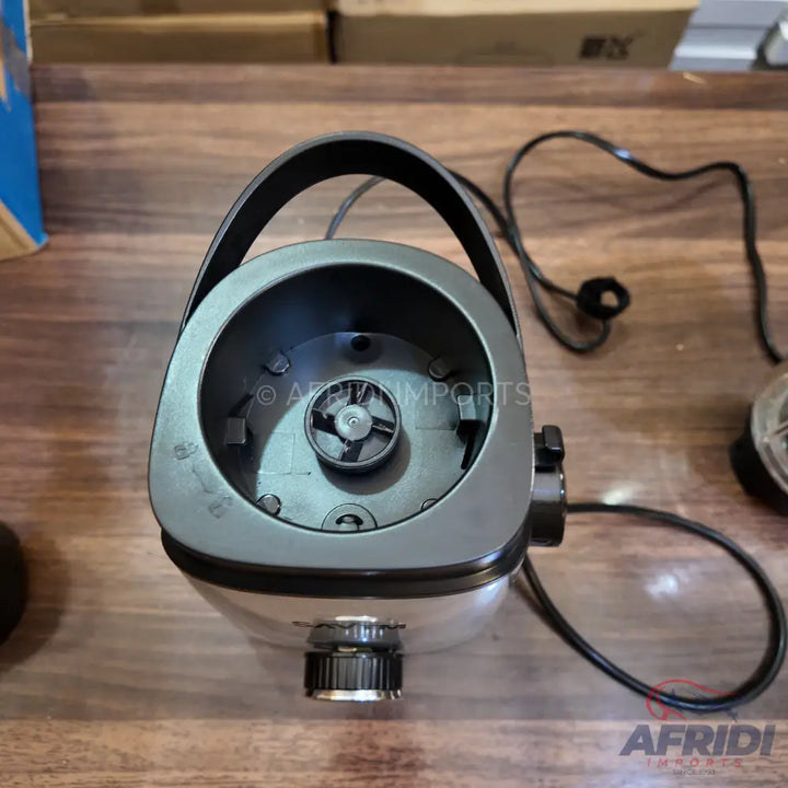 A black and white blender base with a visible blade assembly and an attached power cord.
