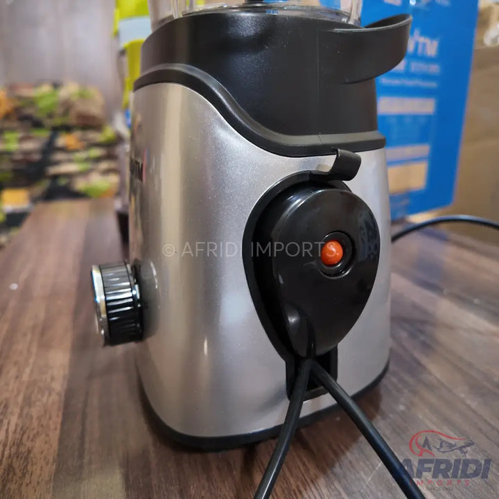 Silver and black electric blender base with a power cord and a control knob.