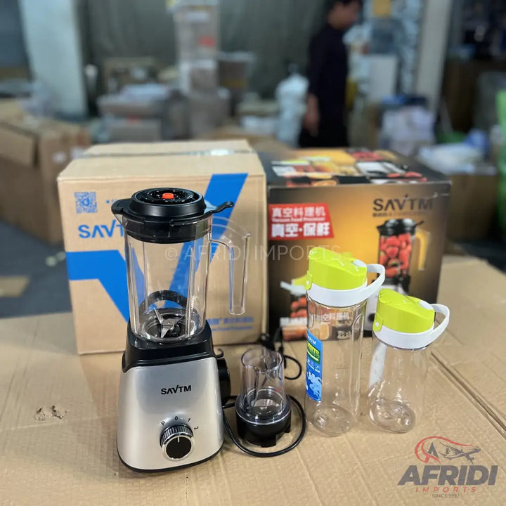 A silver and black blender with a large pitcher and an additional smaller grinding cup, accompanied by two clear plastic sports bottles with green lids.