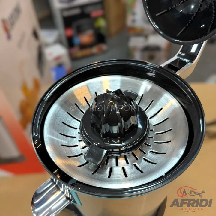 Top-down view of a citrus juicer with a black reamer and a silver strainer.