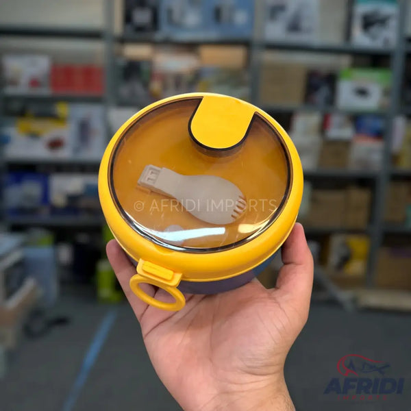 Yellow round lunchbox with a clear lid and an included spork.