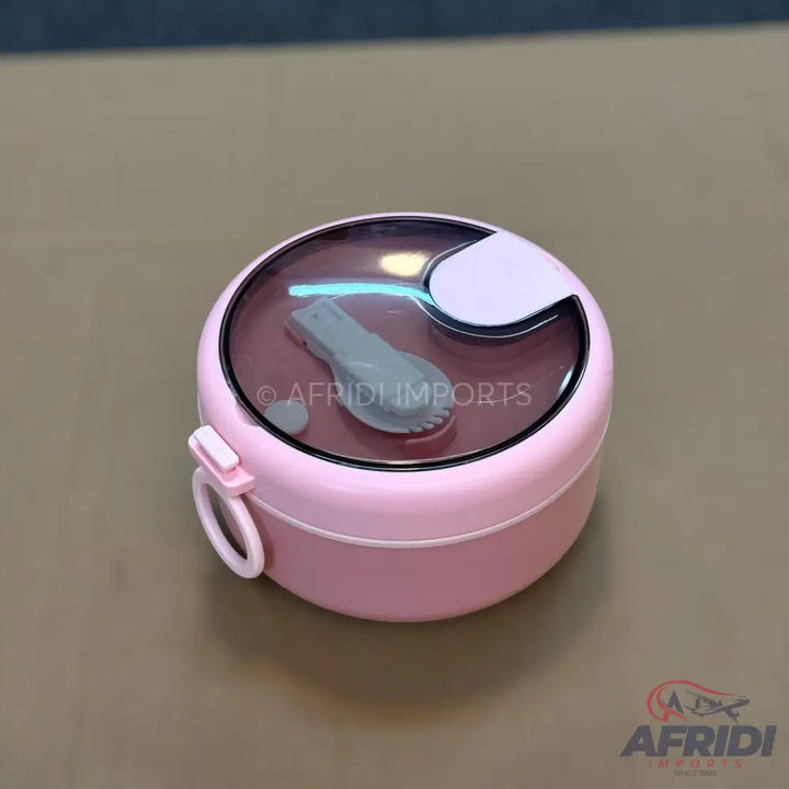 Pink round lunchbox with a transparent lid and an integrated spork.