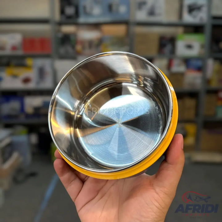 Shiny stainless steel food container with a yellow rim.