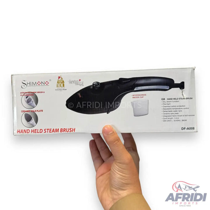 A boxed handheld steam brush for clothing.