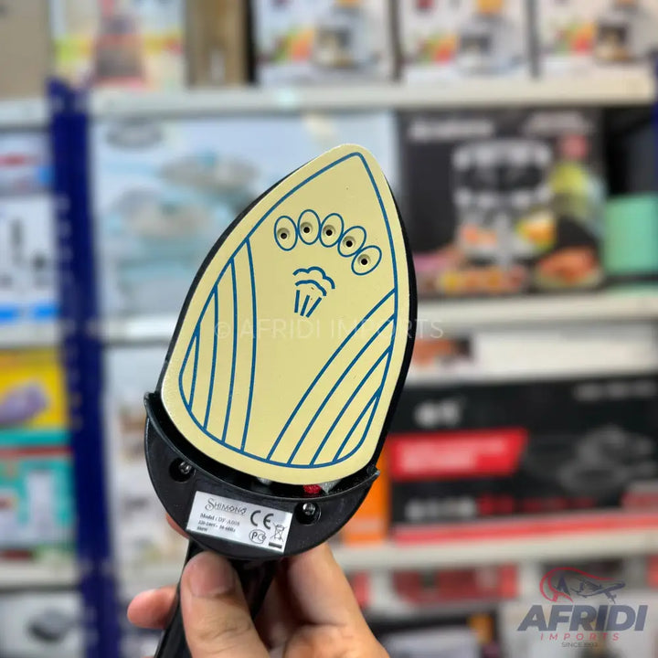 A handheld mini steam iron with a whimsical alien face design.