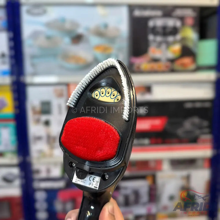 Black handheld garment steamer with a red lint brush attachment and a bristled brush head.
