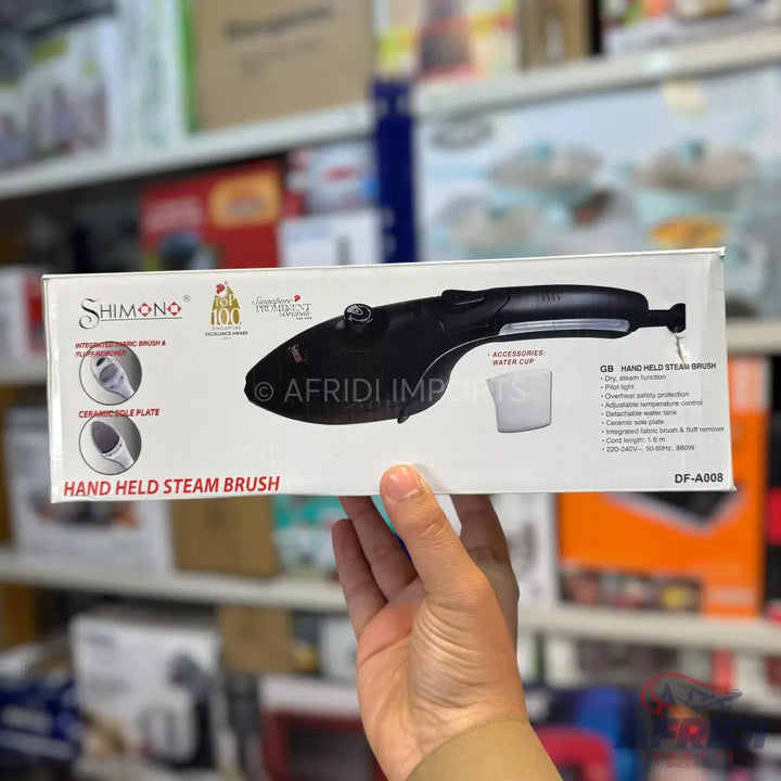 A black handheld steam brush with an integrated lint brush and ceramic soleplate.