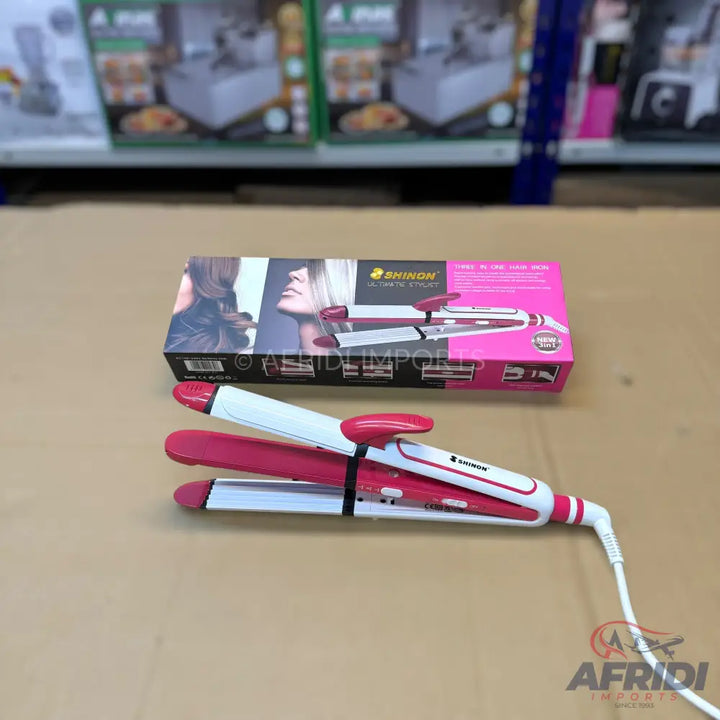 Pink and white 3-in-1 hair styling tool with interchangeable plates for straightening, curling, and crimping.