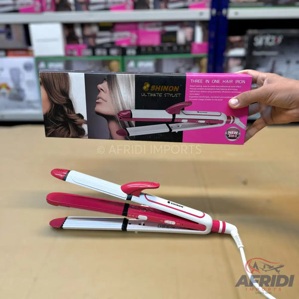 Pink and white three-in-one hair styling iron.