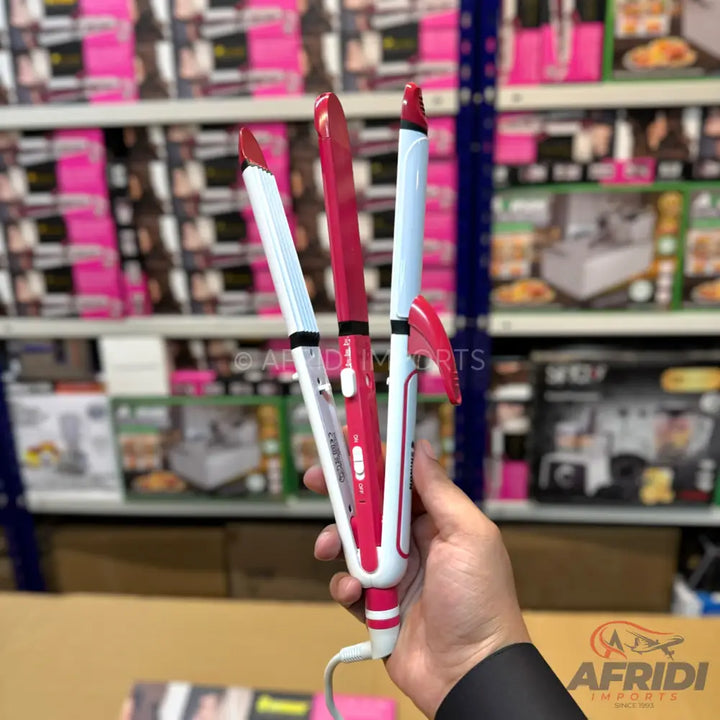 A pink and white 3-in-1 hair styling tool, combining a straightener, crimper, and curler.