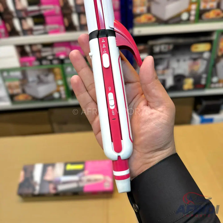 White and pink hair curler with temperature control and on/off switch.