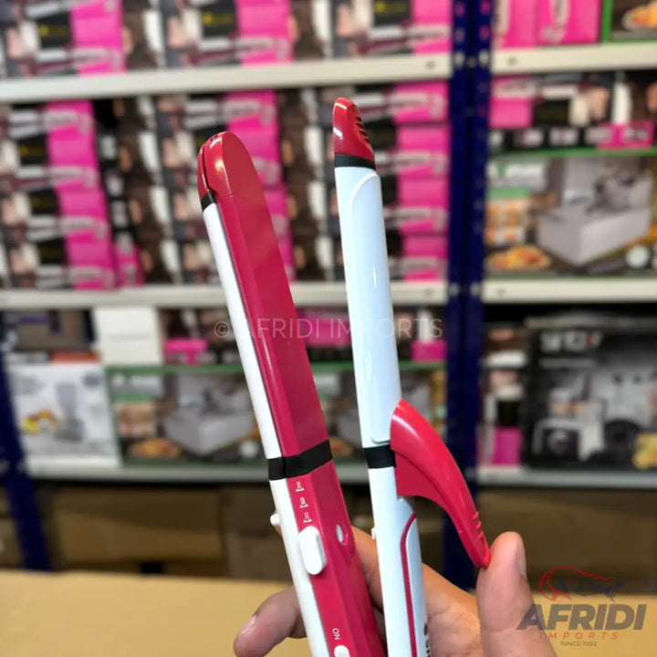 Pink and white ceramic hair straightener with temperature control.