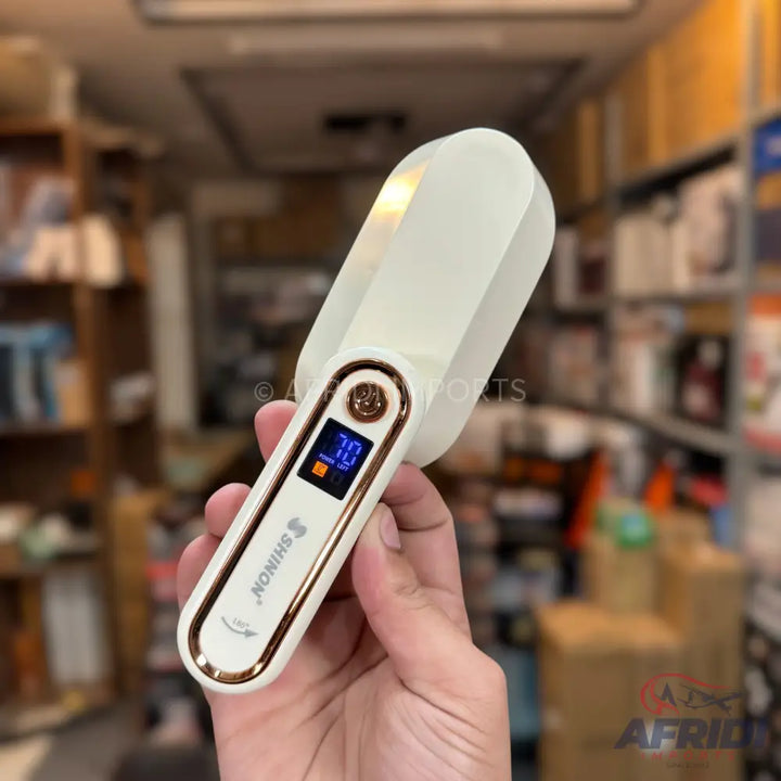 White and gold handheld digital pet food scoop.