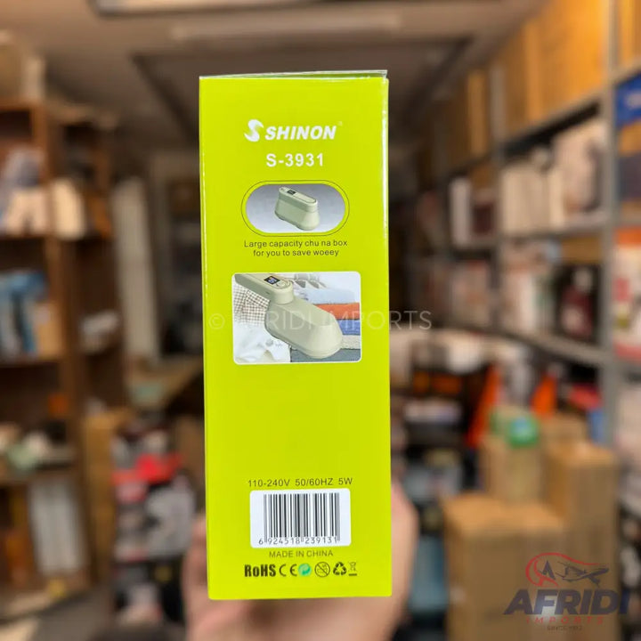 A green box for a SHINON S-3931 lint remover with a large capacity shaving box, operating at 110-240V, 50/60Hz, 5W, and made in China.