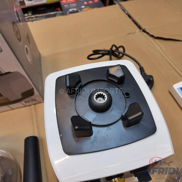 A white and black blender base with a power cord.