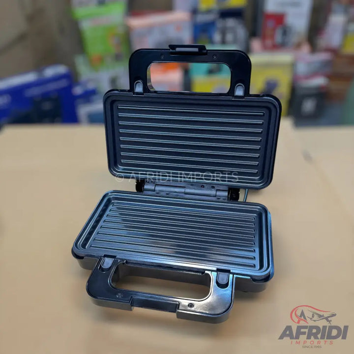 Open, black electric grill or sandwich maker with ribbed cooking plates.