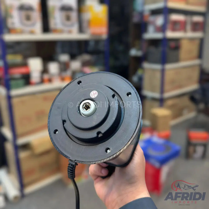 The base of a black electric kettle with a power cord.