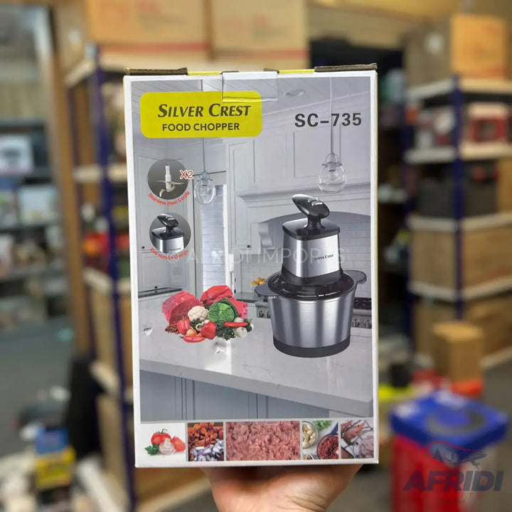 A Silver Crest SC-735 food chopper with a stainless steel bowl and a black motor unit, capable of chopping various foods including meat and vegetables.