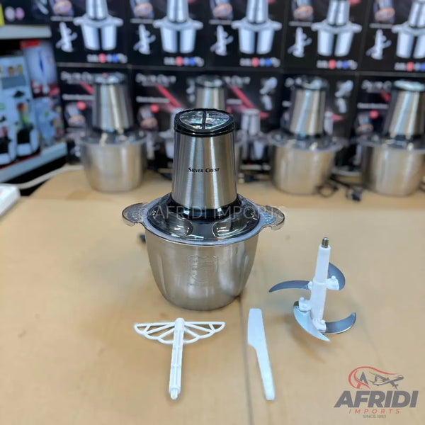 Stainless steel electric food chopper with multiple blades and attachments.