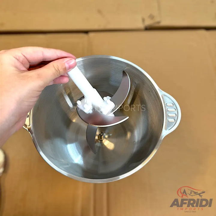 A stainless steel food processor bowl with a two-tiered blade assembly.