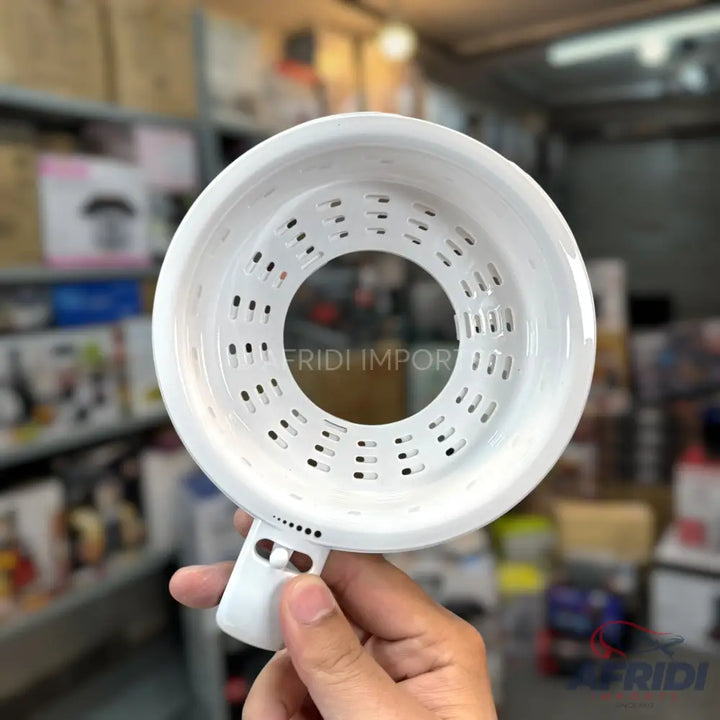 White, perforated, handheld kitchen strainer with a handle.