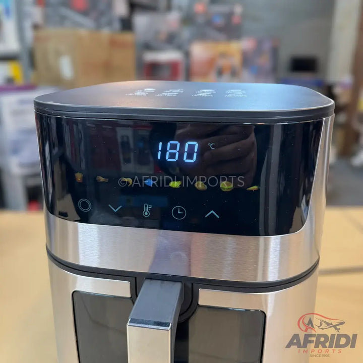 Silver and black digital air fryer with a clear display showing ’180 °C’ and various cooking icons.
