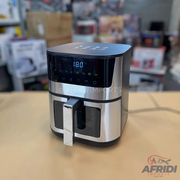 A silver and black digital air fryer with a visible temperature display.