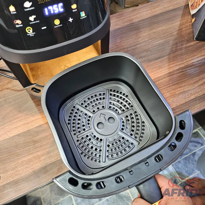 Black air fryer with a pull-out basket and digital display.