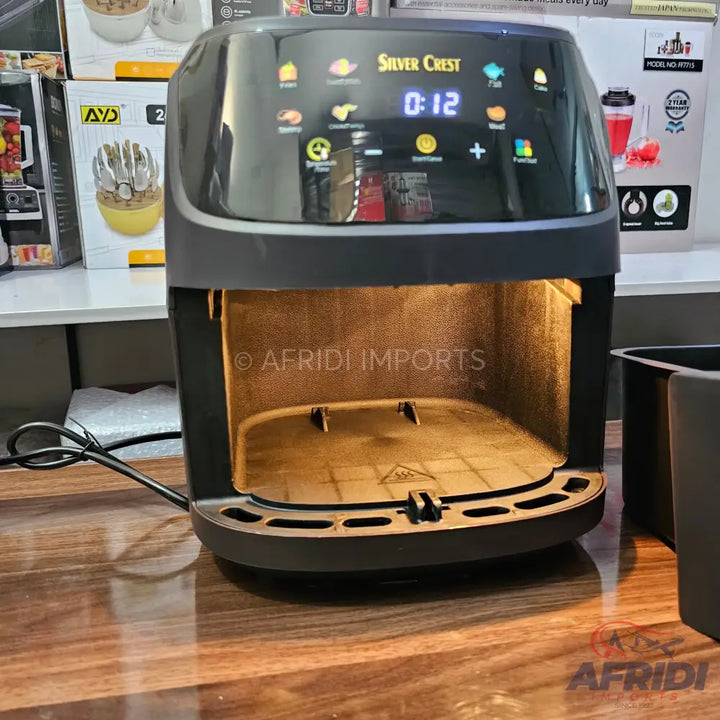 Black digital air fryer with a visible empty cooking chamber.