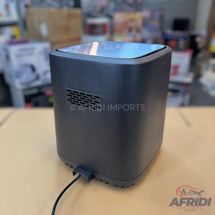 Black square-shaped air fryer with a reflective top panel.