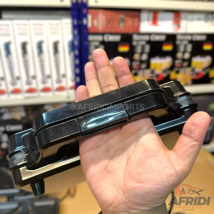 A black, handheld waffle maker with a sleek design.