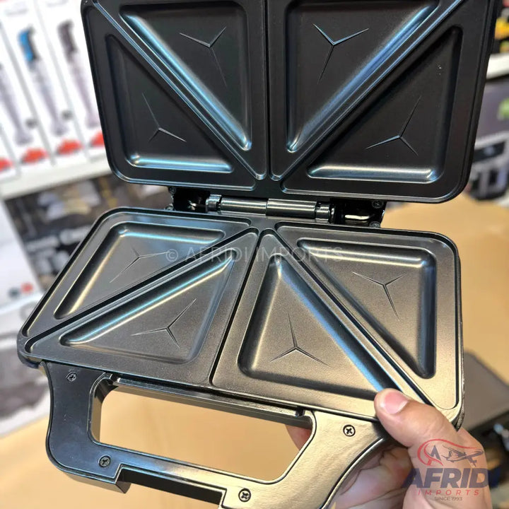 An open sandwich maker with non-stick triangular cooking plates.