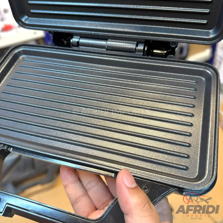 An open electric grill or sandwich maker with removable, non-stick griddle plates.