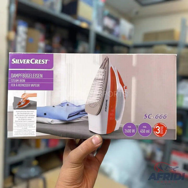 A SilverCrest steam iron, model SC-666, with 2600W power, a 450ml water tank, and a 3-year warranty.