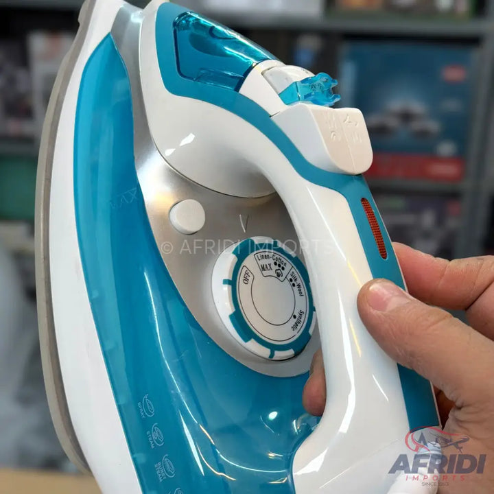 A teal and white steam iron with a temperature control dial and a water reservoir.
