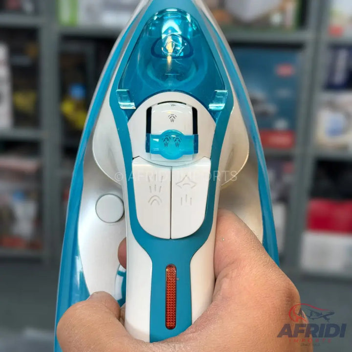 A blue and white steam iron with visible water tank and control buttons.